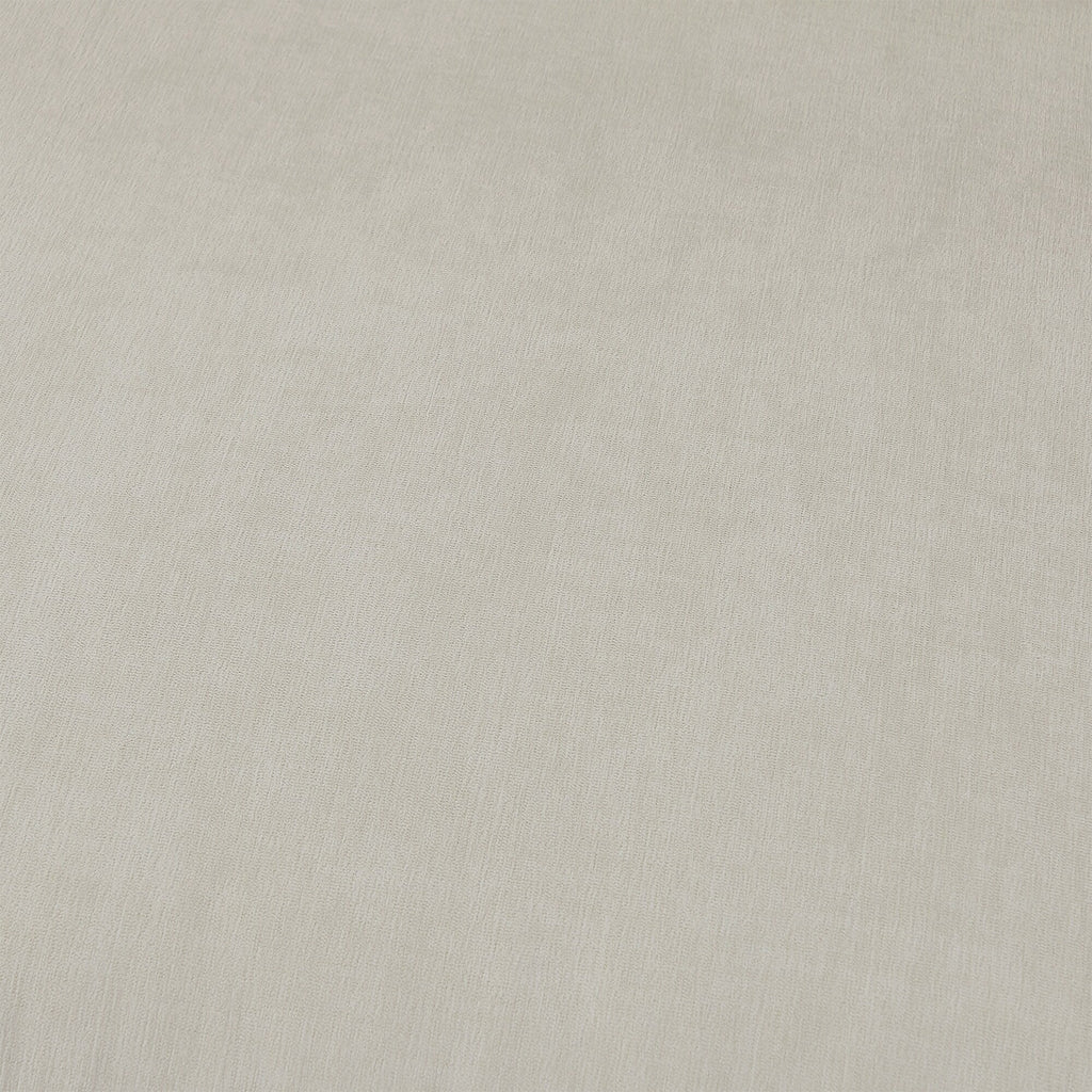 Canapé en forme de L de 260 cm en polyester avec pouf réversible.